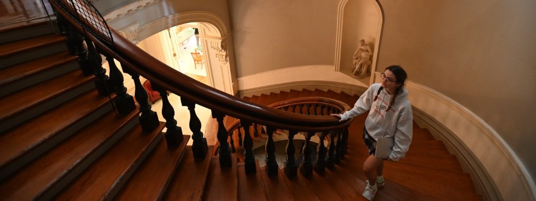 student on spiral staircase