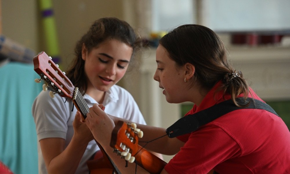 students playing guitar together